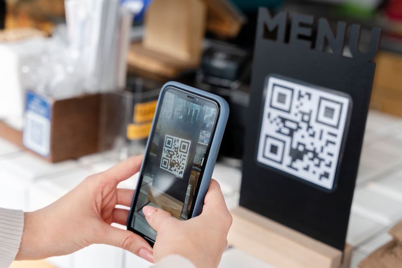 Guest scanning a QR code menu at a restaurant counter